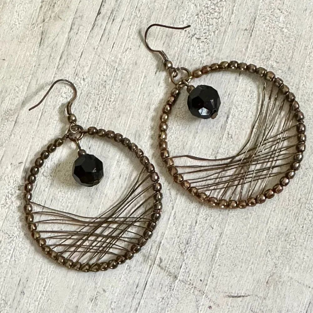 Brass tone black beaded circle wire earrings
